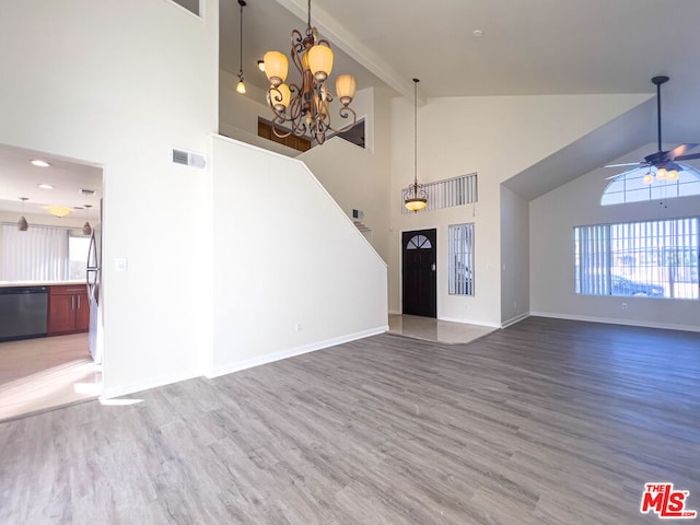 foyer with hardwood / wood-style floors, ceiling fan with notable chandelier, and high vaulted ceiling