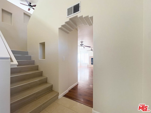 stairway featuring hardwood / wood-style floors and a towering ceiling