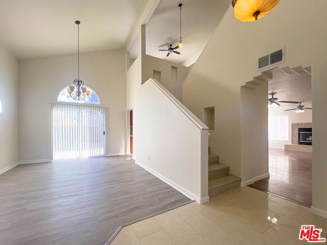 interior space featuring wood-type flooring, high vaulted ceiling, and ceiling fan