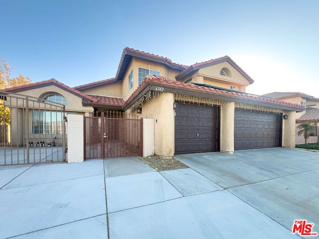 mediterranean / spanish house featuring a garage