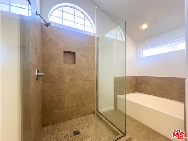 bathroom featuring tile patterned flooring, shower with separate bathtub, and a healthy amount of sunlight