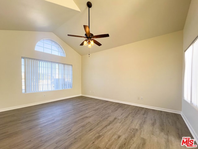 spare room with high vaulted ceiling, ceiling fan, dark hardwood / wood-style flooring, and a wealth of natural light