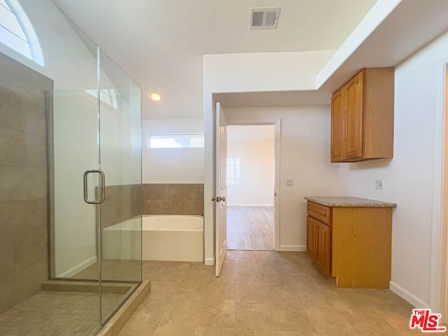 bathroom featuring tile patterned flooring, vanity, and independent shower and bath