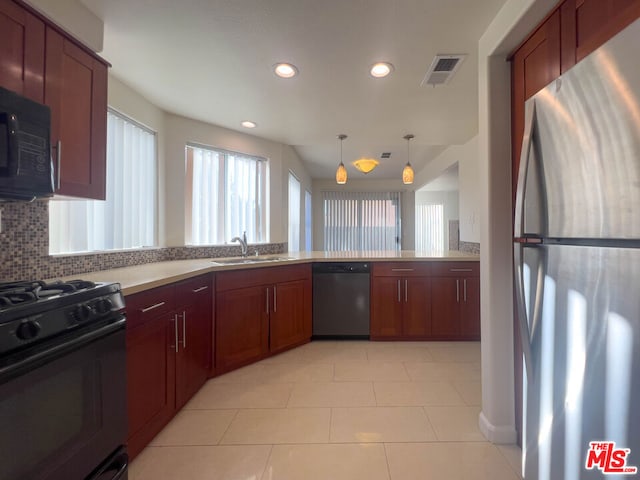 kitchen with sink, decorative light fixtures, decorative backsplash, light tile patterned floors, and black appliances