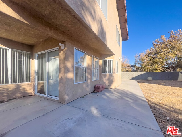 view of property exterior with a patio area