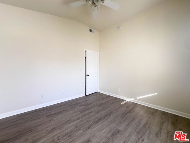 spare room featuring vaulted ceiling, ceiling fan, and dark hardwood / wood-style floors