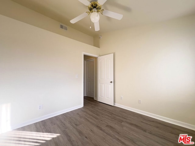 unfurnished room featuring ceiling fan and dark hardwood / wood-style floors