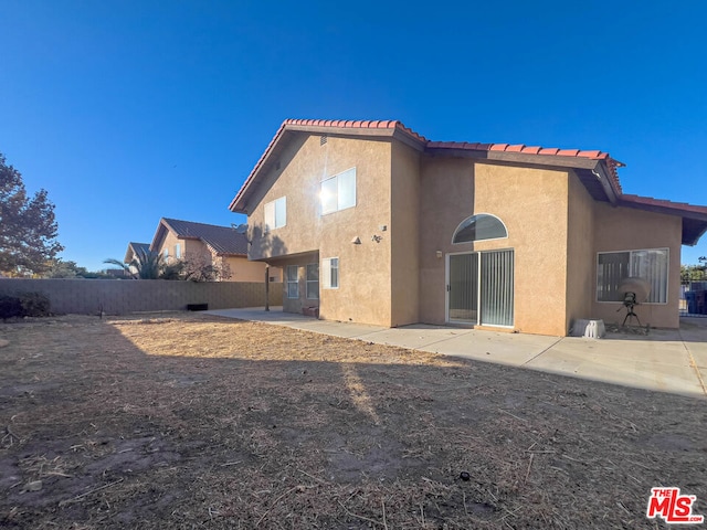 rear view of property featuring a patio