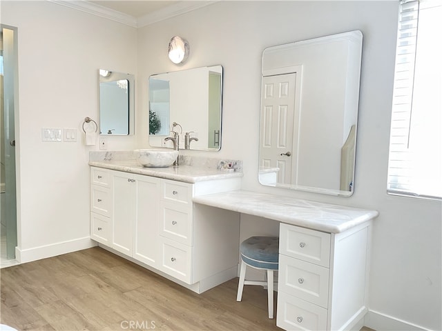 bathroom with hardwood / wood-style flooring, vanity, and crown molding