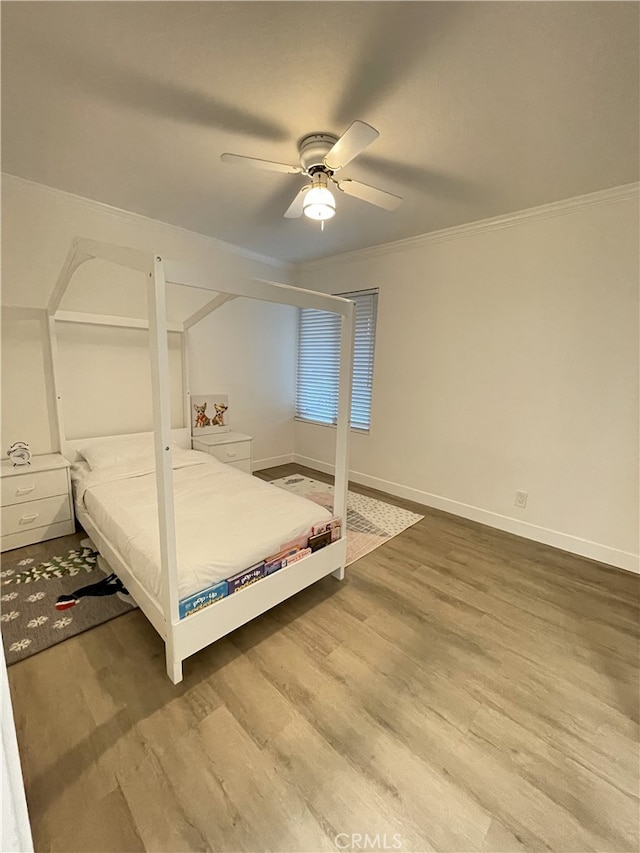 bedroom with ceiling fan, wood-type flooring, and ornamental molding