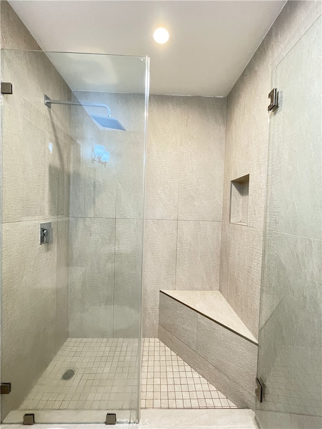 bathroom with a shower with door