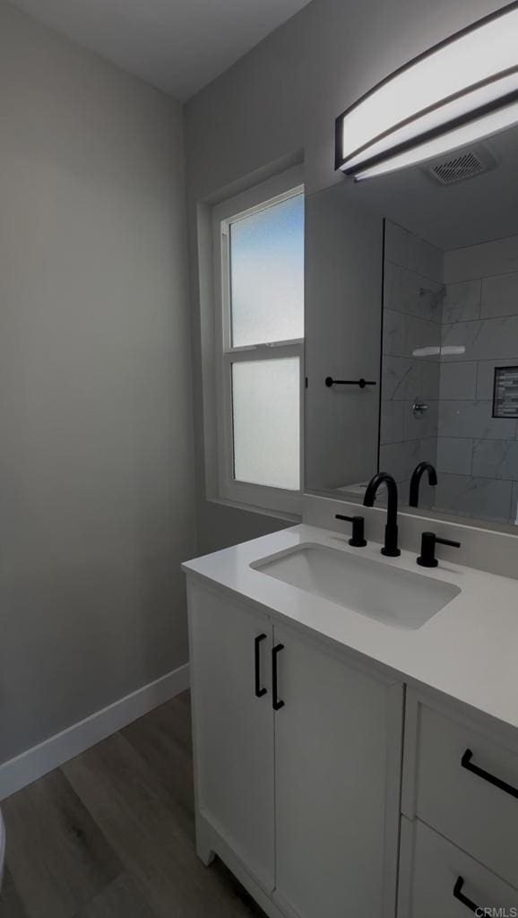 bathroom with vanity and hardwood / wood-style flooring