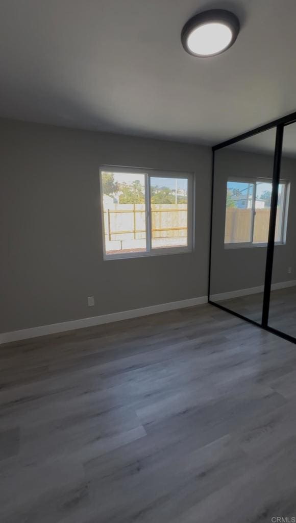 unfurnished room featuring hardwood / wood-style flooring