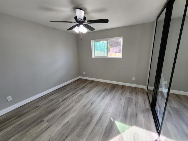 unfurnished bedroom featuring ceiling fan and light hardwood / wood-style flooring