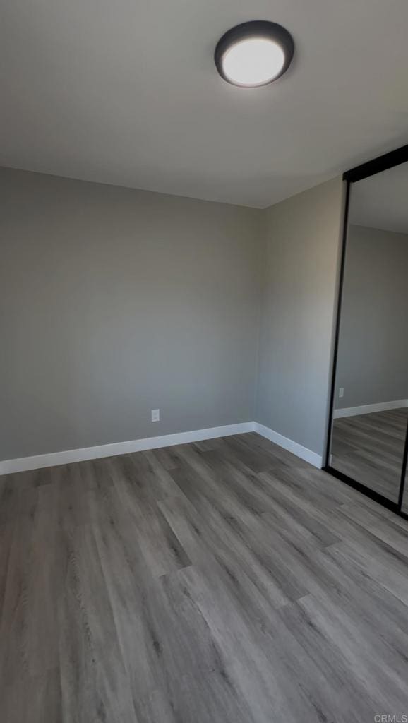 empty room with hardwood / wood-style flooring