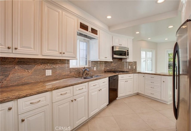 kitchen featuring sink, white cabinetry, stainless steel appliances, and a wealth of natural light