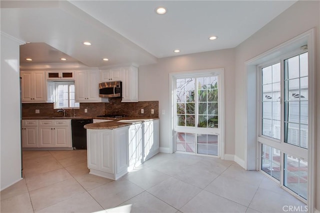 kitchen featuring backsplash, white cabinetry, dishwasher, and light tile patterned floors