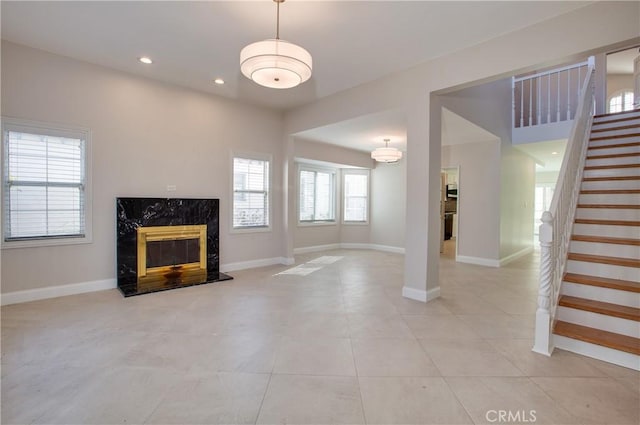 unfurnished living room with a fireplace and light tile patterned flooring