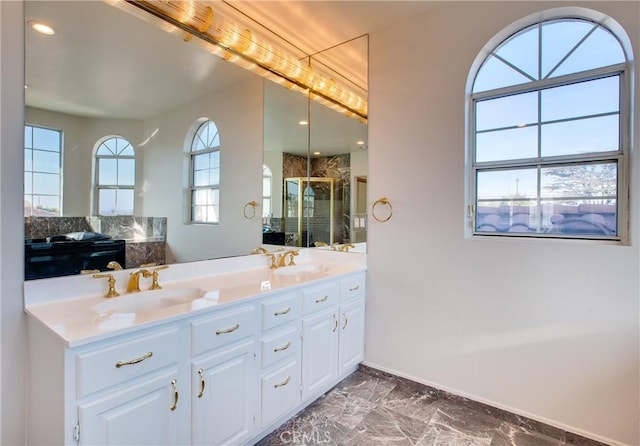 bathroom with vanity and a shower with shower door