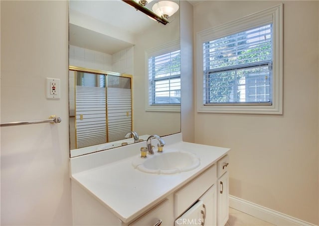 bathroom featuring tile patterned flooring, vanity, and a shower with shower door