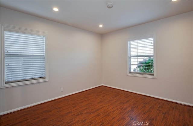 spare room with dark hardwood / wood-style flooring