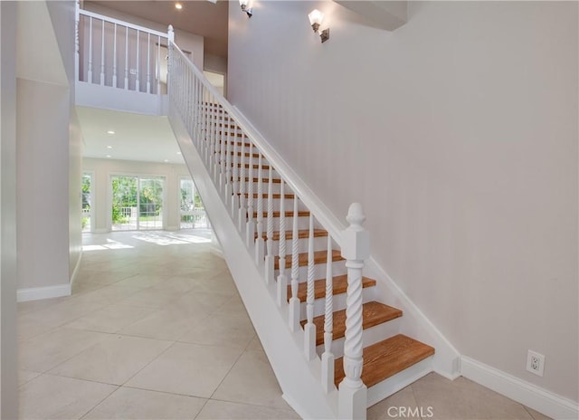 staircase featuring tile patterned floors