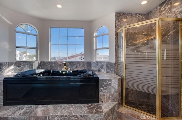 bathroom with shower with separate bathtub