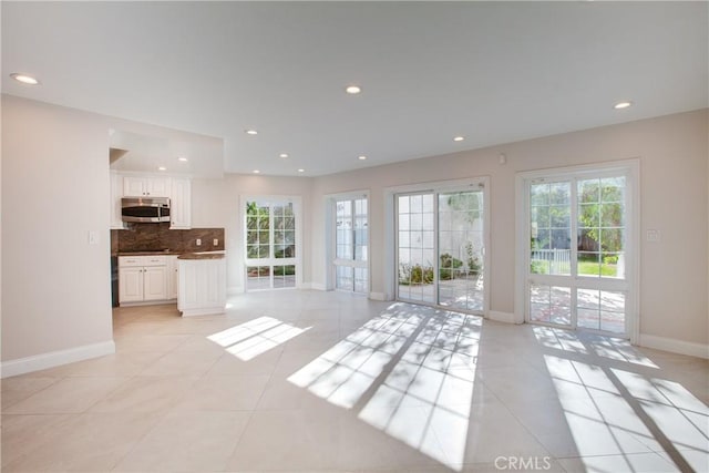 unfurnished living room featuring light tile patterned floors