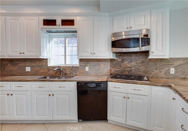 kitchen featuring appliances with stainless steel finishes, backsplash, white cabinetry, and sink