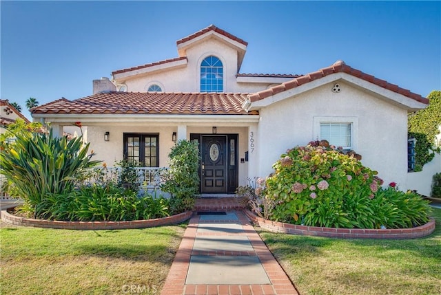 mediterranean / spanish-style house featuring a front lawn