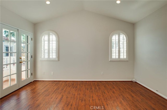 spare room featuring french doors, vaulted ceiling, and hardwood / wood-style flooring