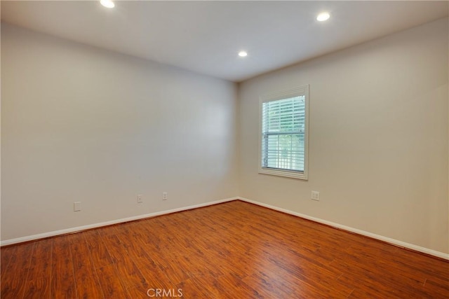 spare room with hardwood / wood-style flooring