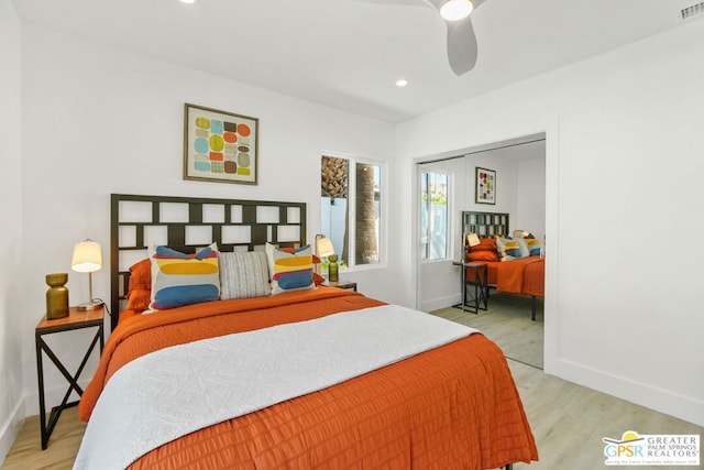 bedroom with light hardwood / wood-style flooring, a closet, and ceiling fan