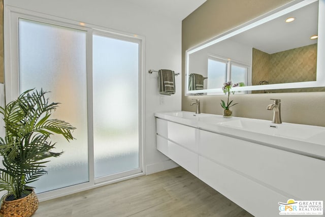 bathroom with hardwood / wood-style flooring and vanity