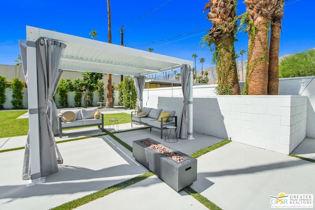 view of patio featuring an outdoor living space with a fire pit