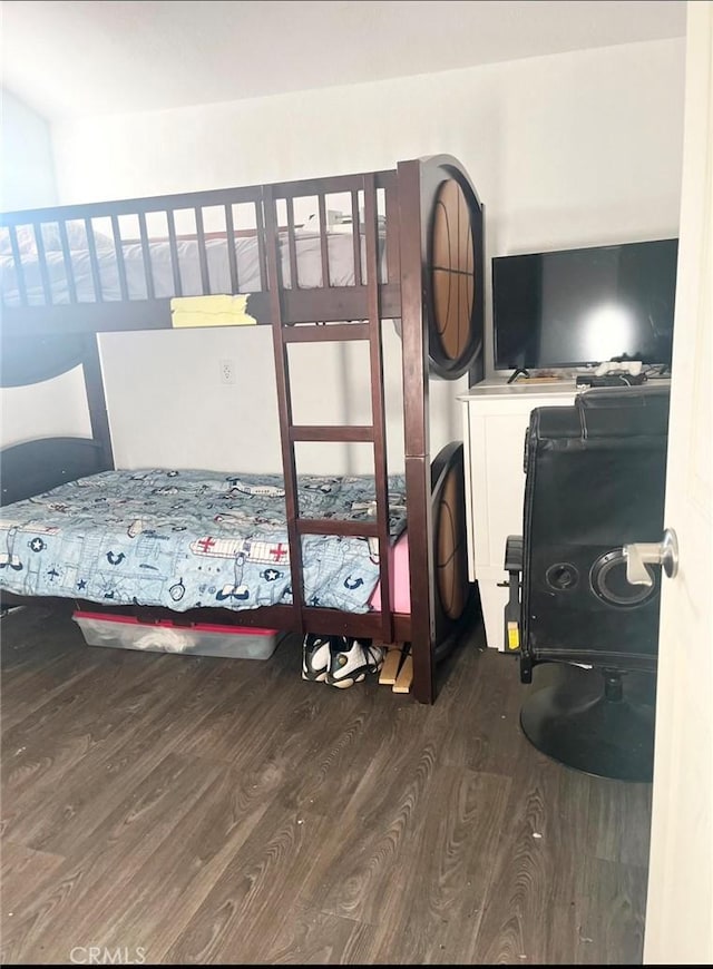 bedroom with dark hardwood / wood-style flooring