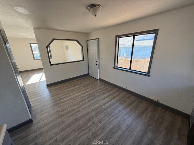 empty room with dark wood-type flooring