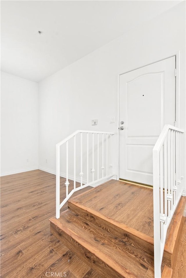 stairs with hardwood / wood-style flooring