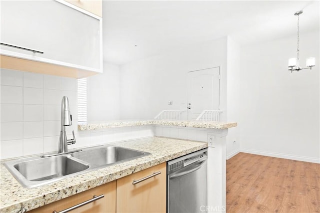 kitchen featuring sink, decorative light fixtures, light hardwood / wood-style flooring, light brown cabinets, and dishwasher