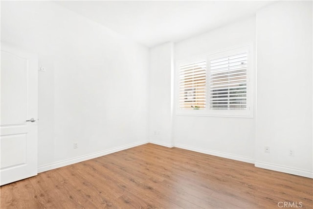 unfurnished room with hardwood / wood-style floors