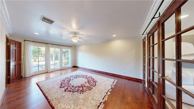 spare room with french doors, crown molding, ceiling fan, and dark wood-type flooring