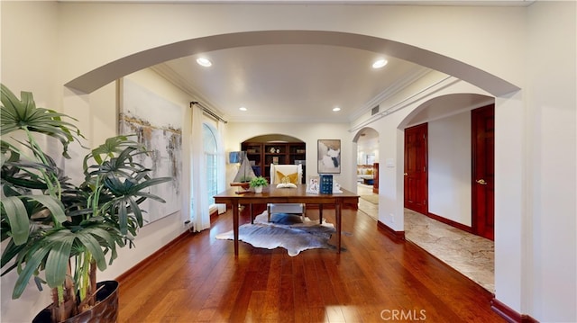 home office featuring ornamental molding and dark wood-type flooring