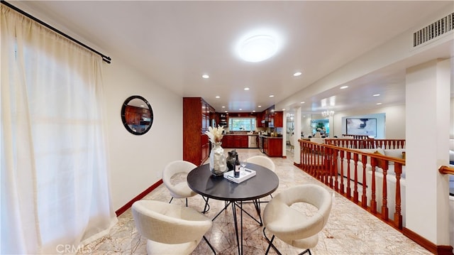 dining space with ornamental molding