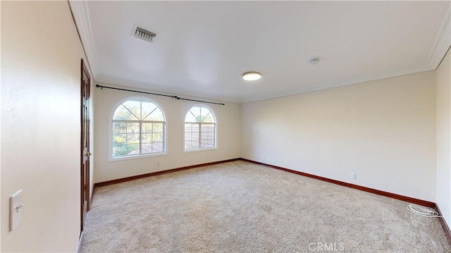 spare room with light colored carpet and ornamental molding