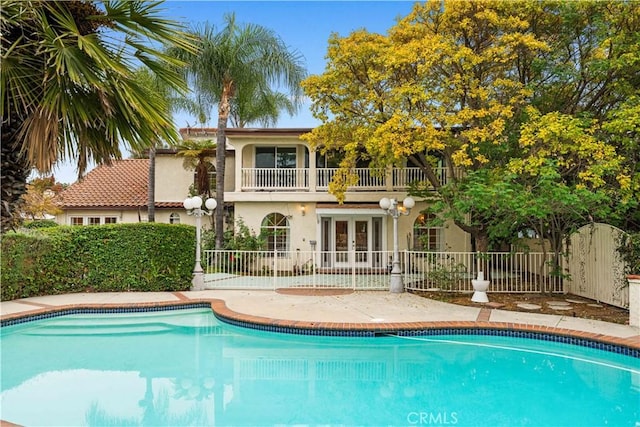 view of pool featuring french doors