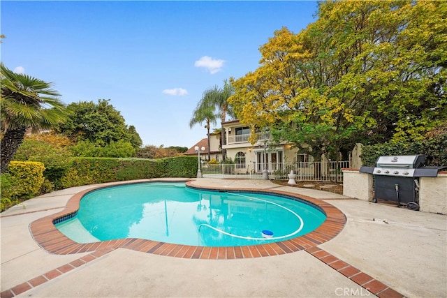 view of swimming pool featuring area for grilling and a patio