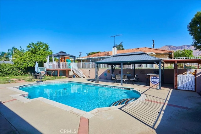 view of swimming pool featuring a gazebo, a mountain view, and a patio