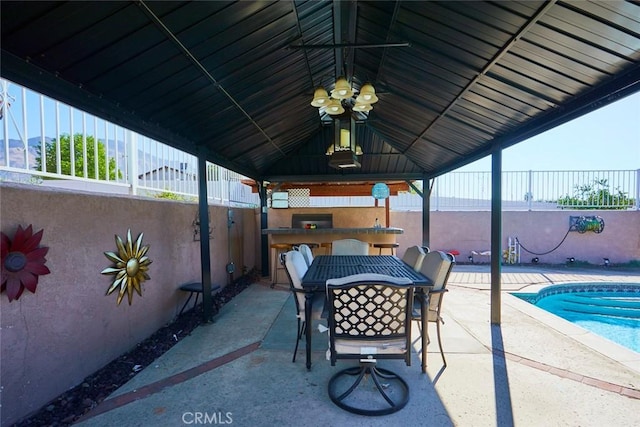 view of patio with a gazebo, an outdoor kitchen, and a fenced in pool