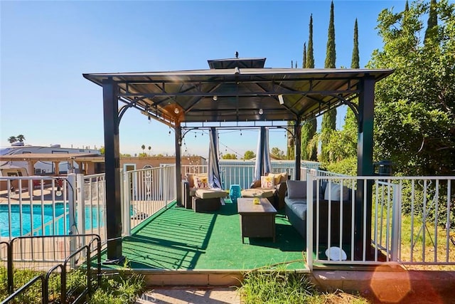 view of patio / terrace featuring a gazebo, an outdoor living space, and a fenced in pool