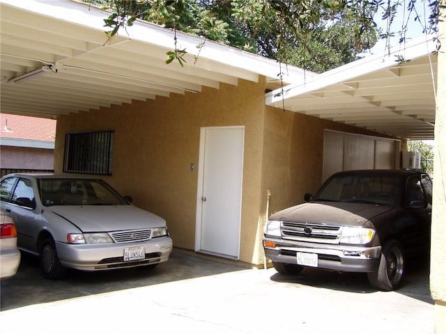 view of vehicle parking featuring a carport